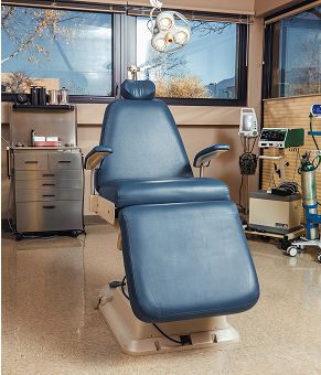 Medical examination chair in clinic setting.