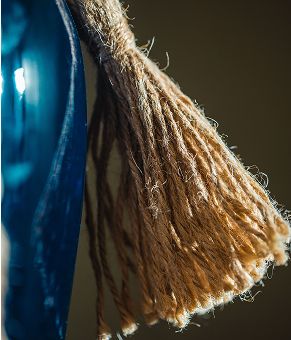 Close-up of a tassel with blue background.