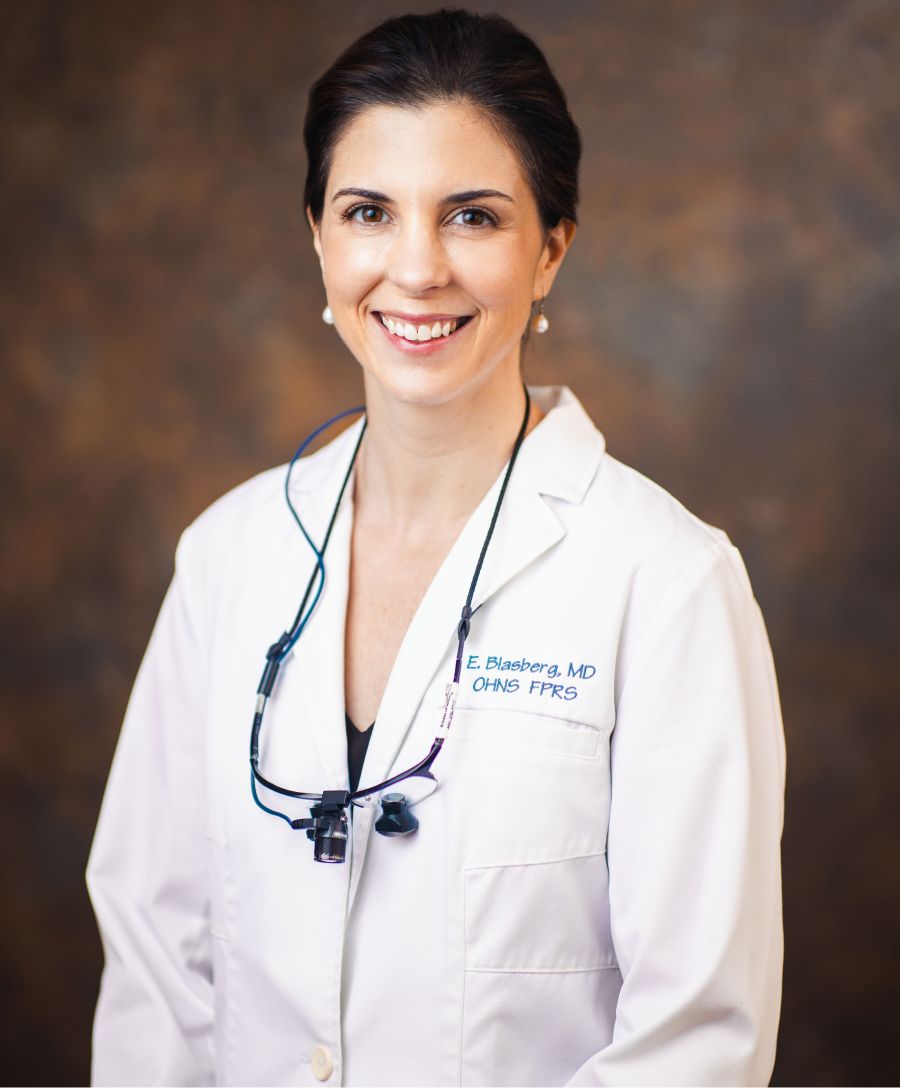 Professional woman posing in an indoor setting.