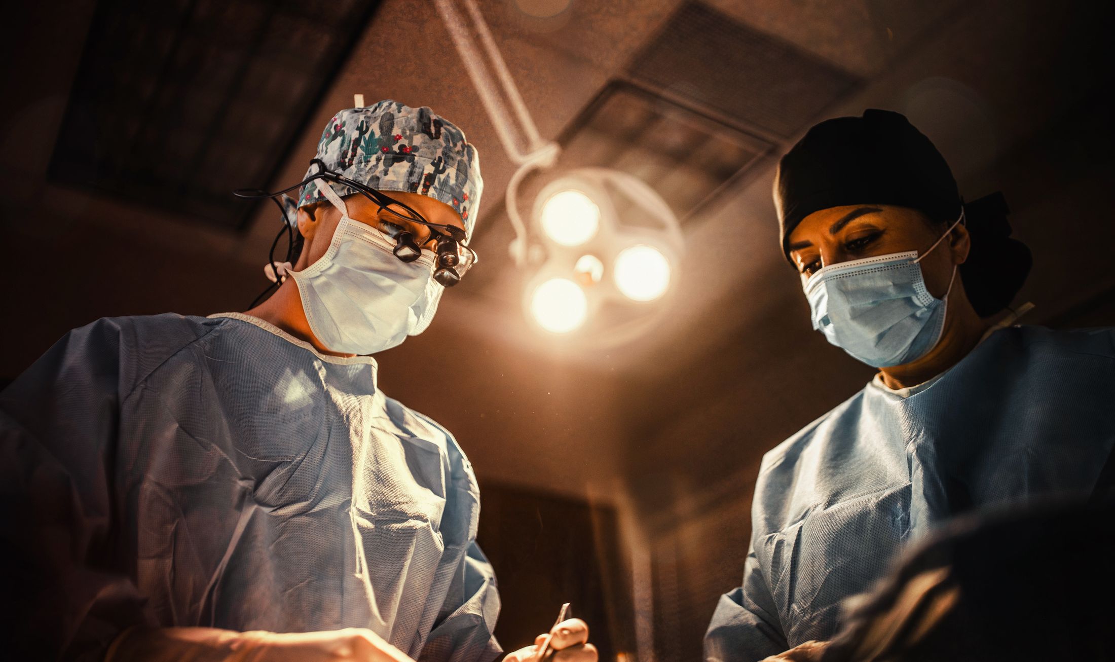 Surgeons performing a procedure in an operating room.